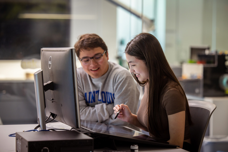 Students working at computer in library