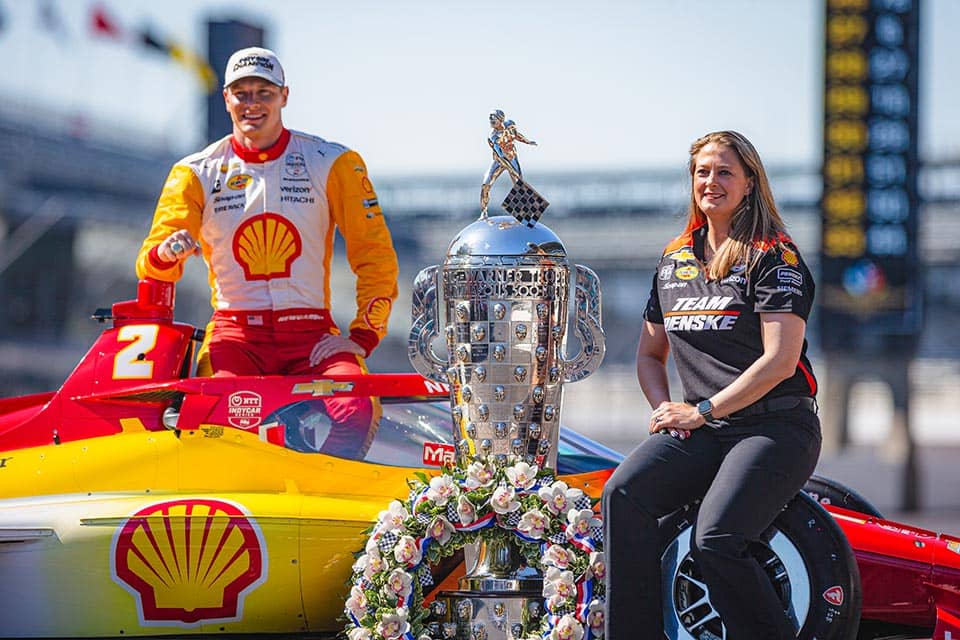 Lauren Sullivan (right) with driver Josef Newgarden and the winning Indy 500 car.