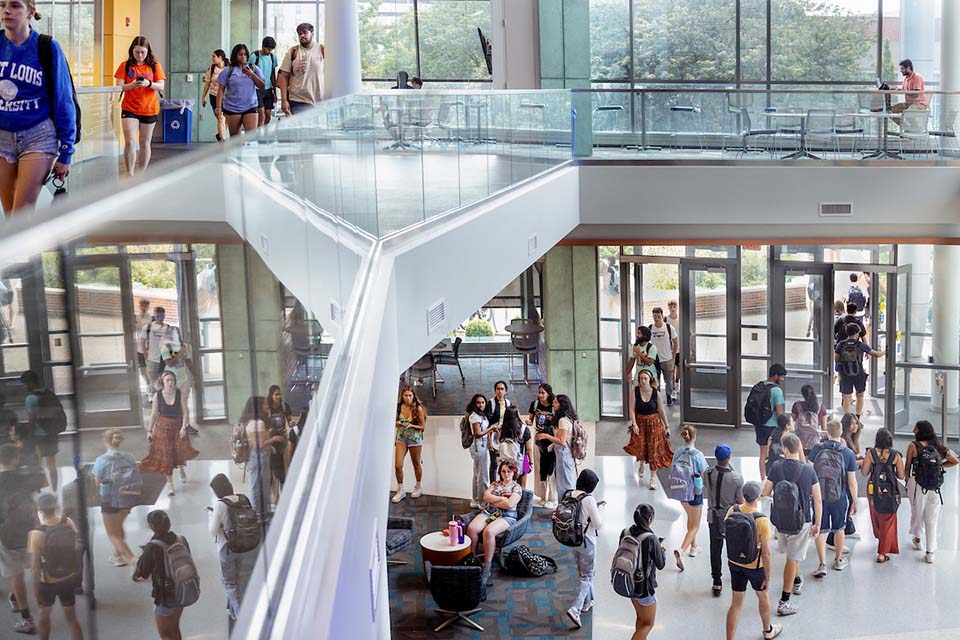  Students walk through an academic building.