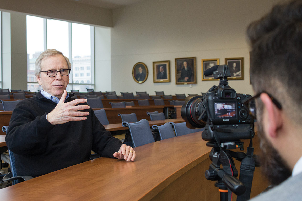 Roger Goldman discusses police licensing reform with a reporter in the John K. Pruellage Courtroom at SLU LAW.