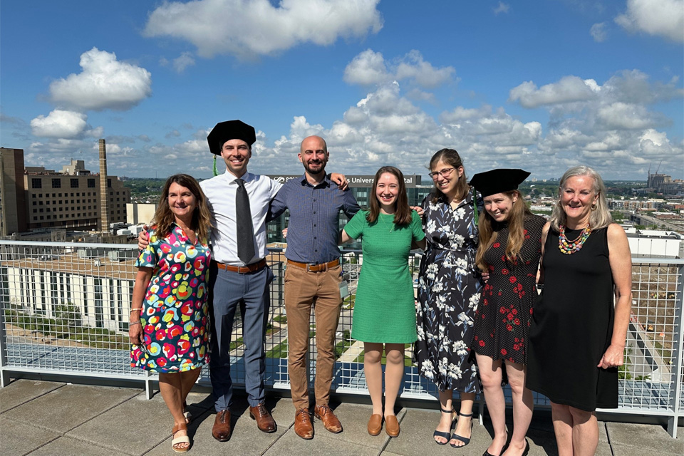 The graduates from 2024 standing on the rooftop of the medical building with their faculty advisors